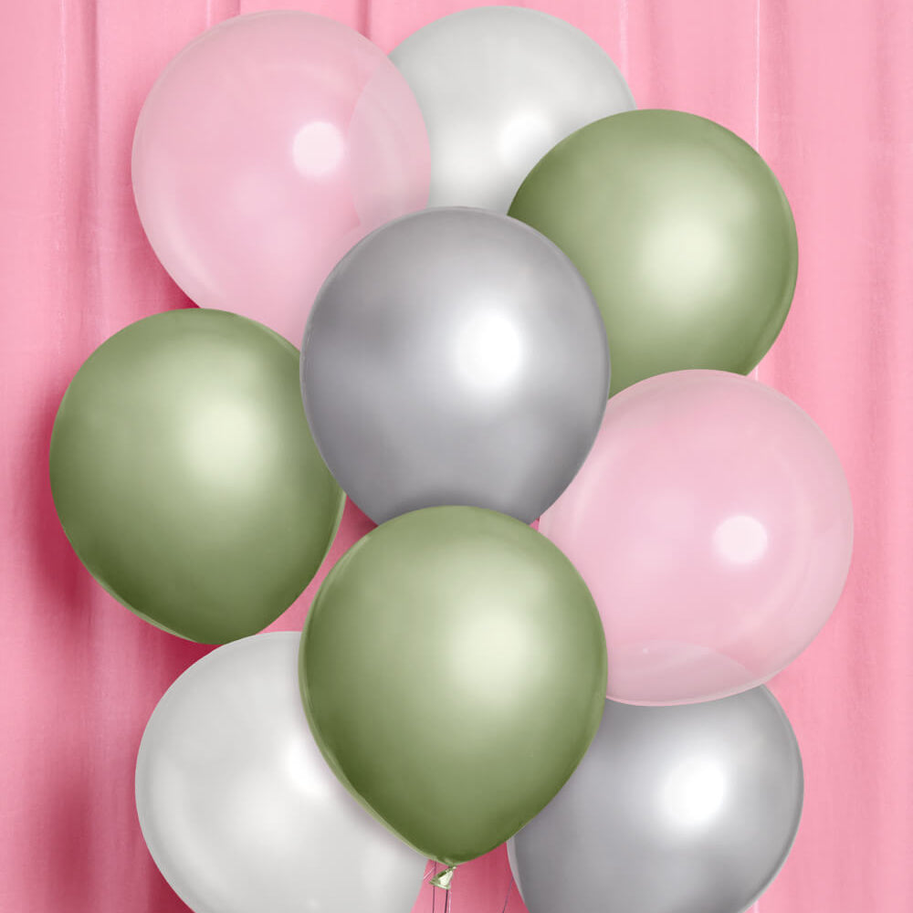 Balloons in pink, green, and silver on a pink background