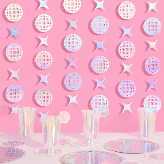 Pastel disco ball pattern on a pink background with party decor.