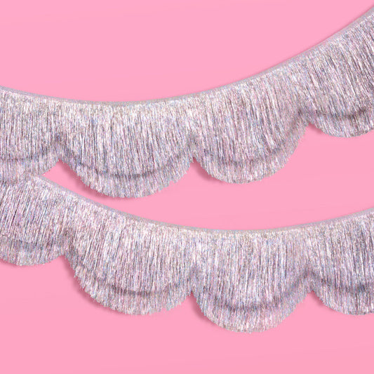 Silver fringe garland on a pink background