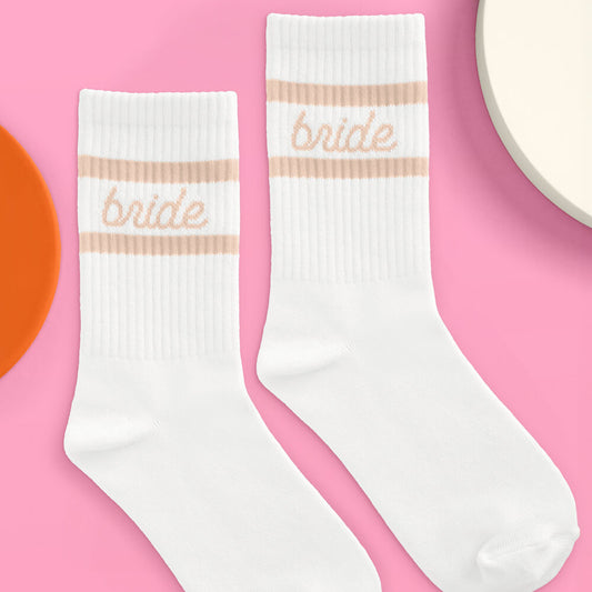 White socks with 'bride' text on a pink background
