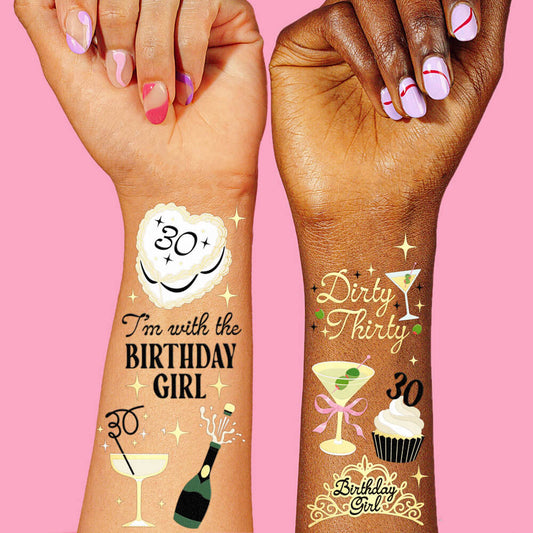 Two hands with temporary tattoos on a pink background