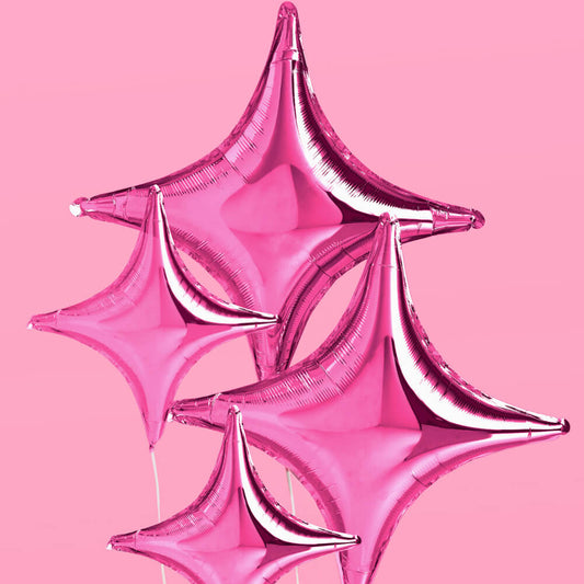 Pink star-shaped balloon against a pink background