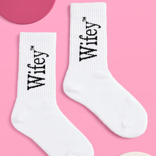 White socks with 'Wifey' text on a pink background