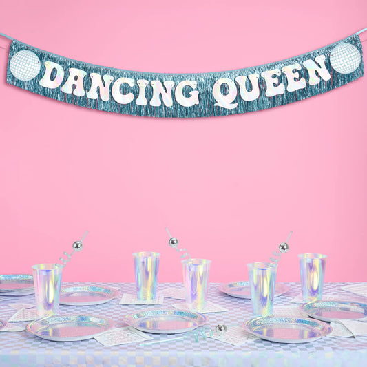 Dancing Queen banner on a pink background with decorative table setting.