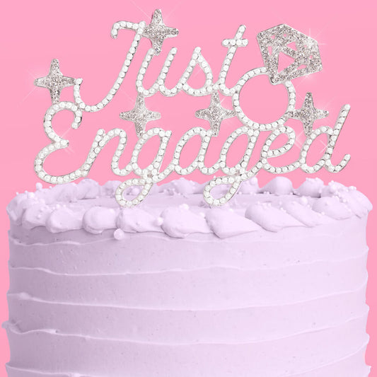 Cake with 'Just Engaged' decoration on a pink background