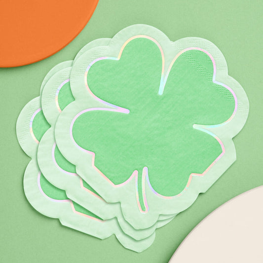 Stack of green four-leaf clover napkins on a green background