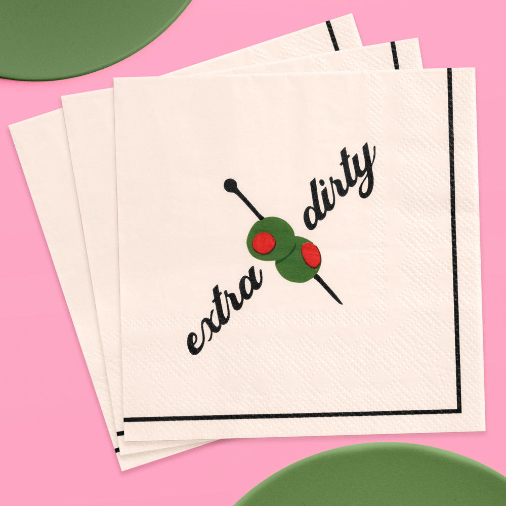 Napkin with 'extra dirty' text and olive graphic on a pink background