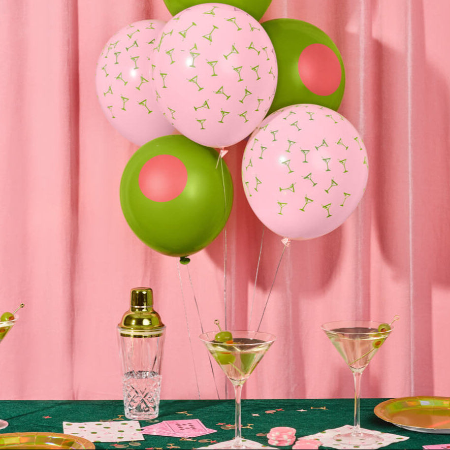 Pink and olive green Dirty 30 martini themed latex balloons floating above birthday party table