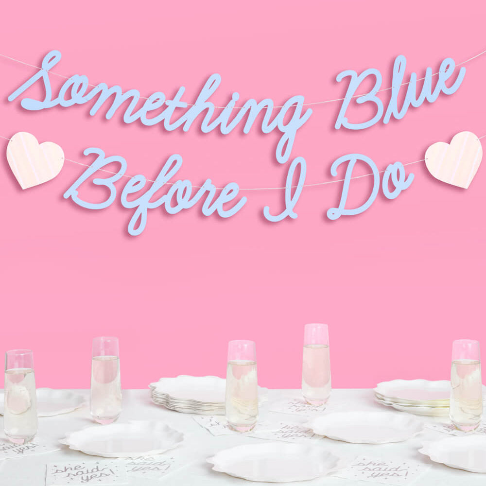 Decorative banner with 'Something Blue Before I Do' text on a pink background with table setting.