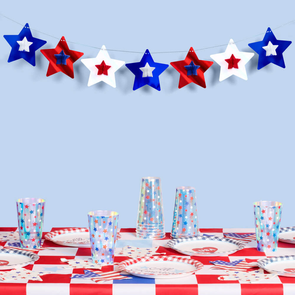 Table setting with red, white, and blue decorations against a light blue background