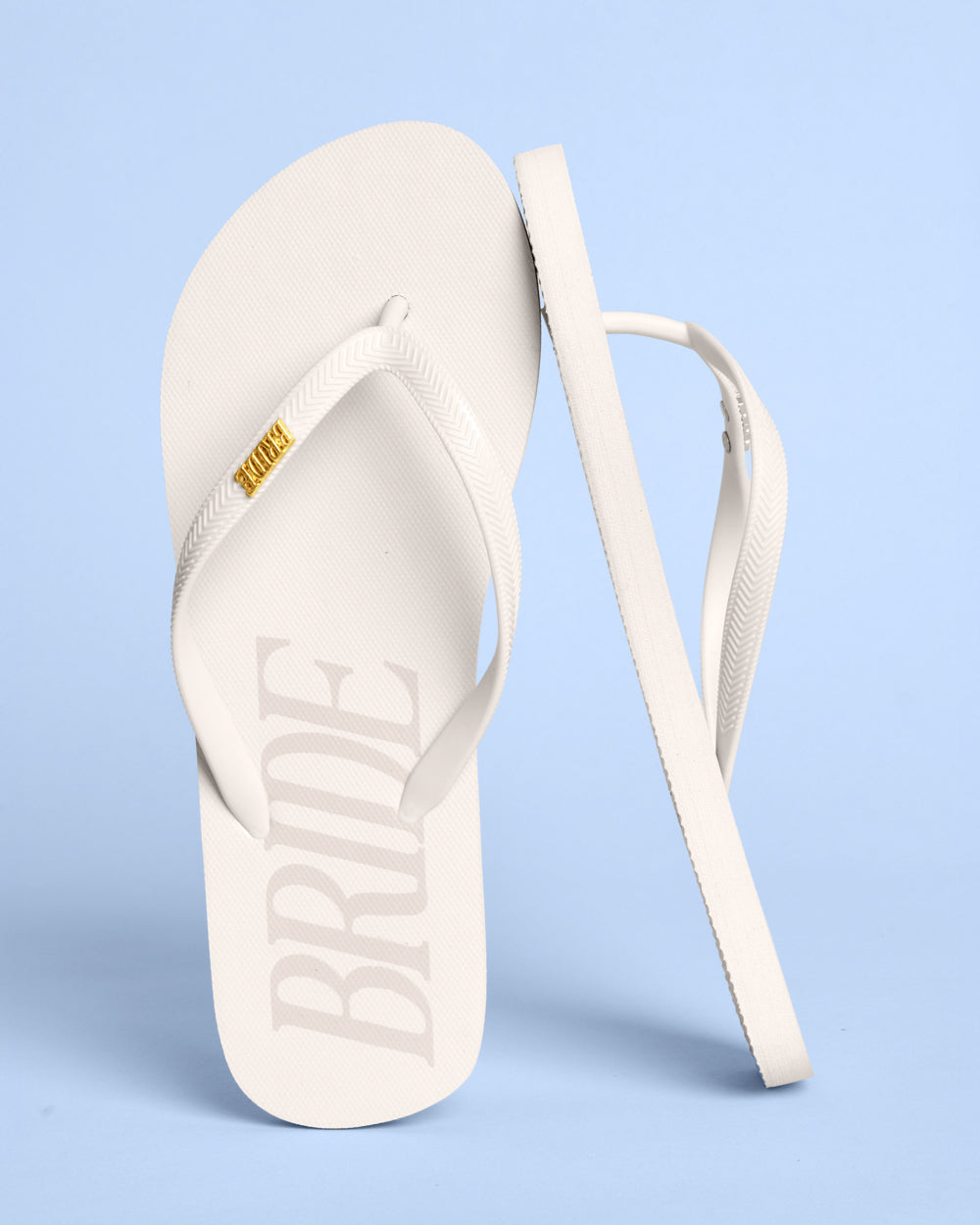 White sandal with 'BRIDE' text on a light blue background