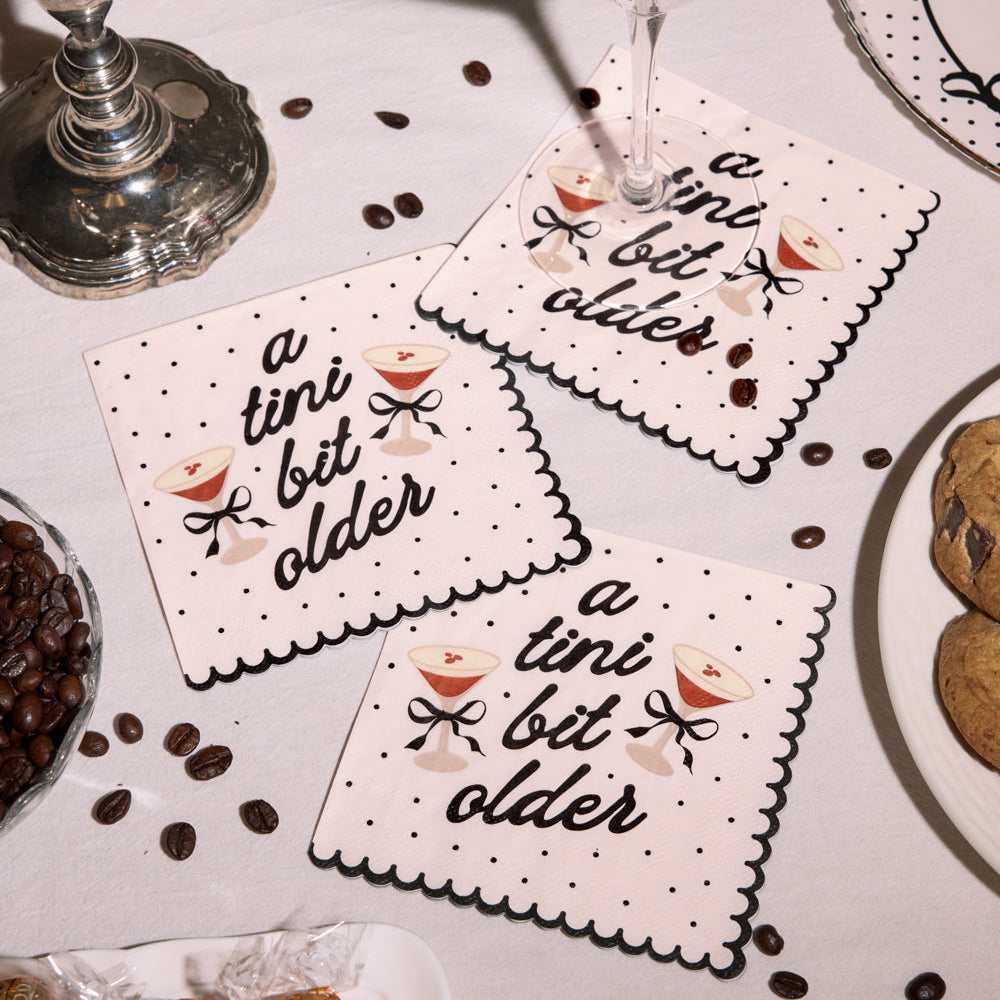 A Tini Bit Older espresso martini cocktail napkins styled on birthday table with coffee beans