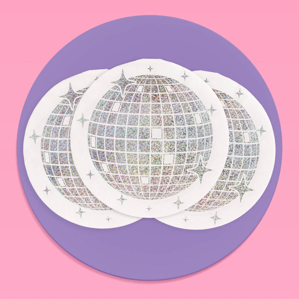 White disco ball design napkins  on a pink background with a purple circle