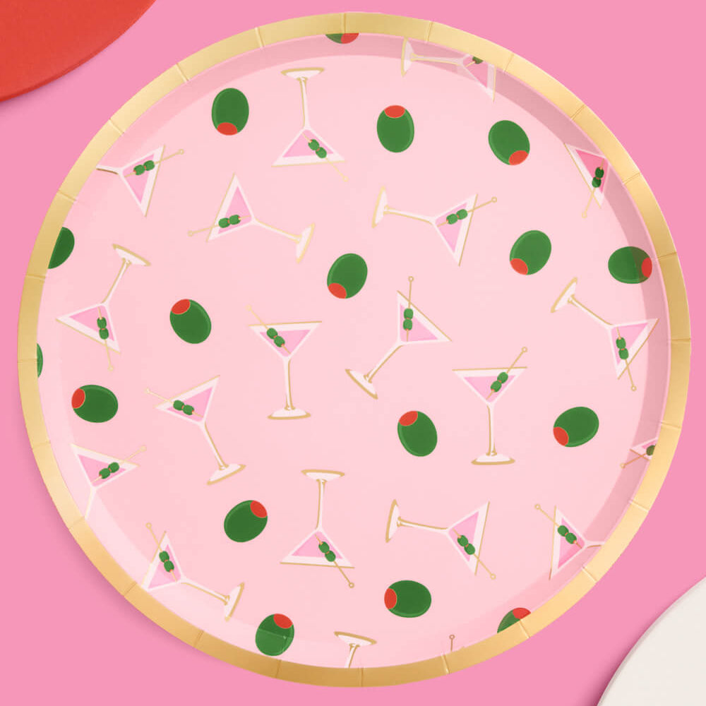 Paper plate with cocktail and olive pattern on a pink background