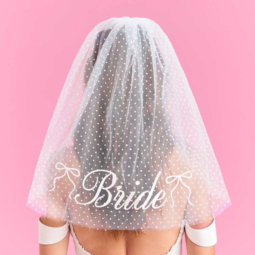 White polka dot veil with 'Bride' text on a pink background