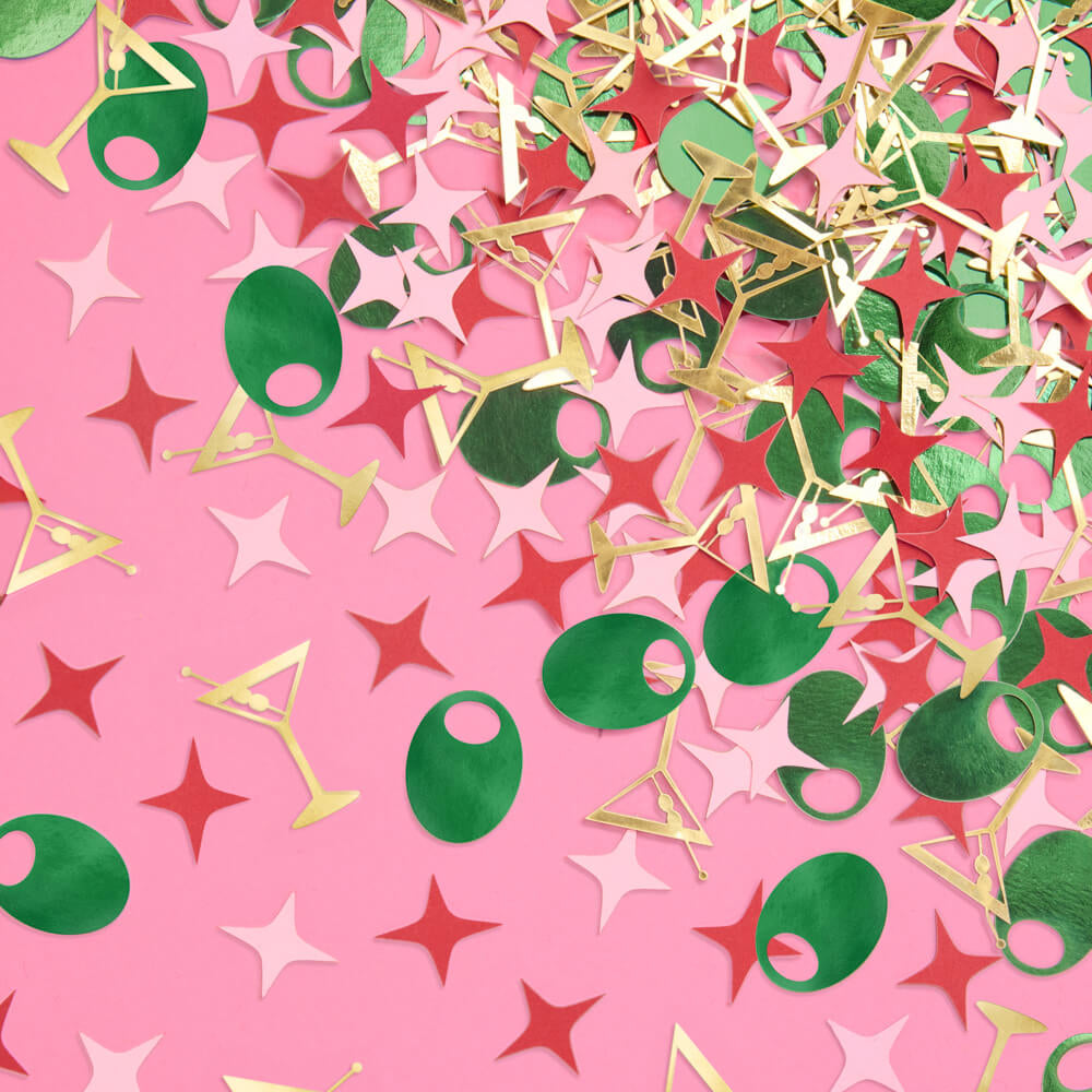 Gold martini glass and green olive foil confetti scattered on pink background for bachelorette party decor