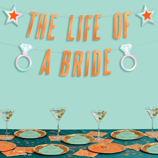 Decorated table with 'The Life of a Bride' theme on a teal background