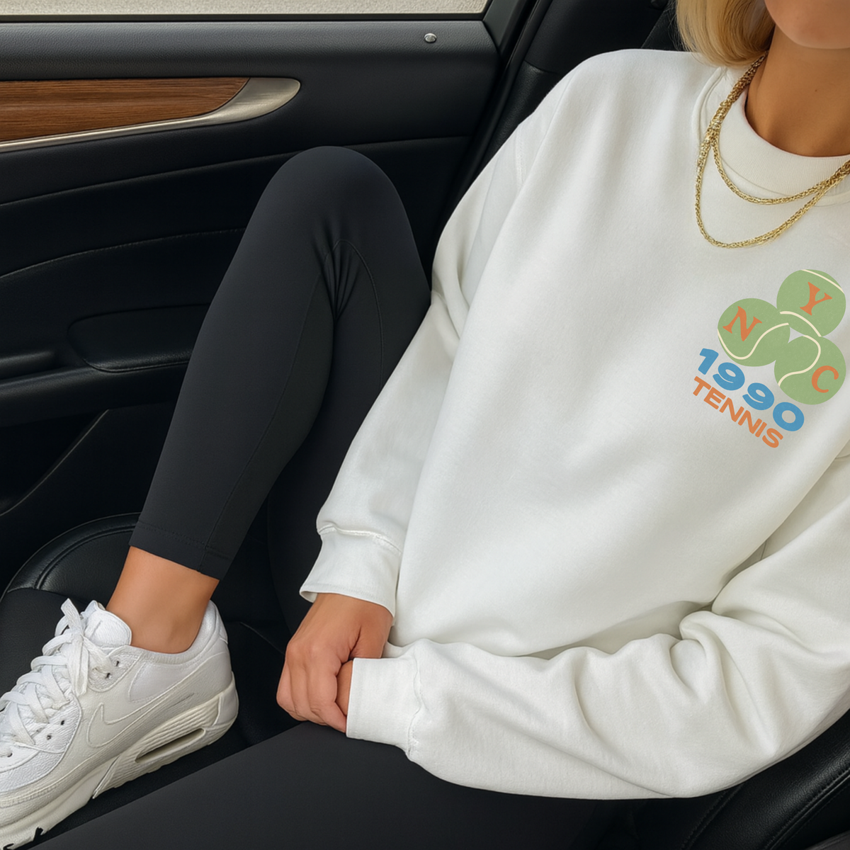 White NYC 1990 tennis sweatshirt styled with leggings inside car