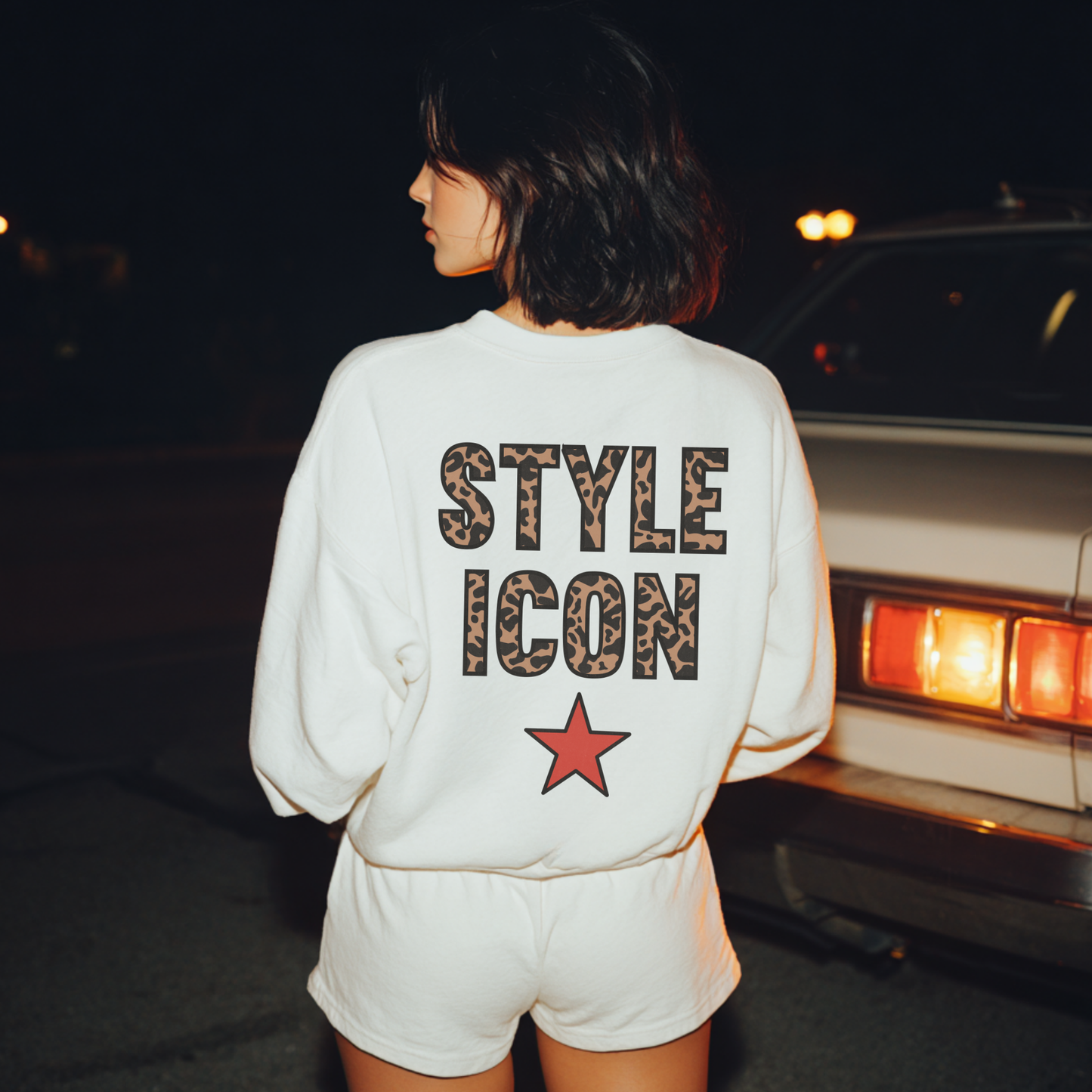 Back view of white Style Icon graphic sweatshirt with leopard lettering and red star