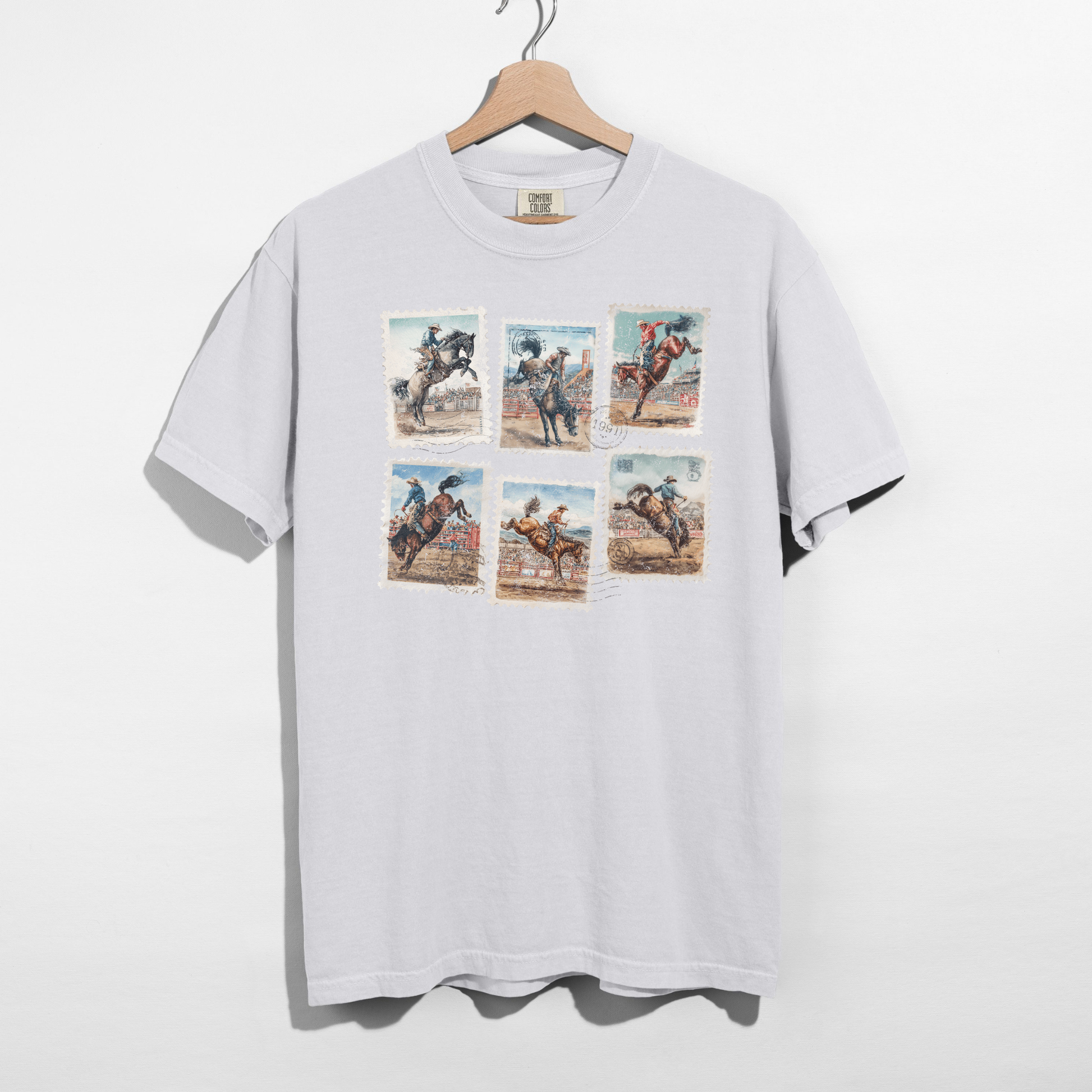 Vintage rodeo stamp graphic tee on white Comfort Colors shirt hanging on wooden hanger