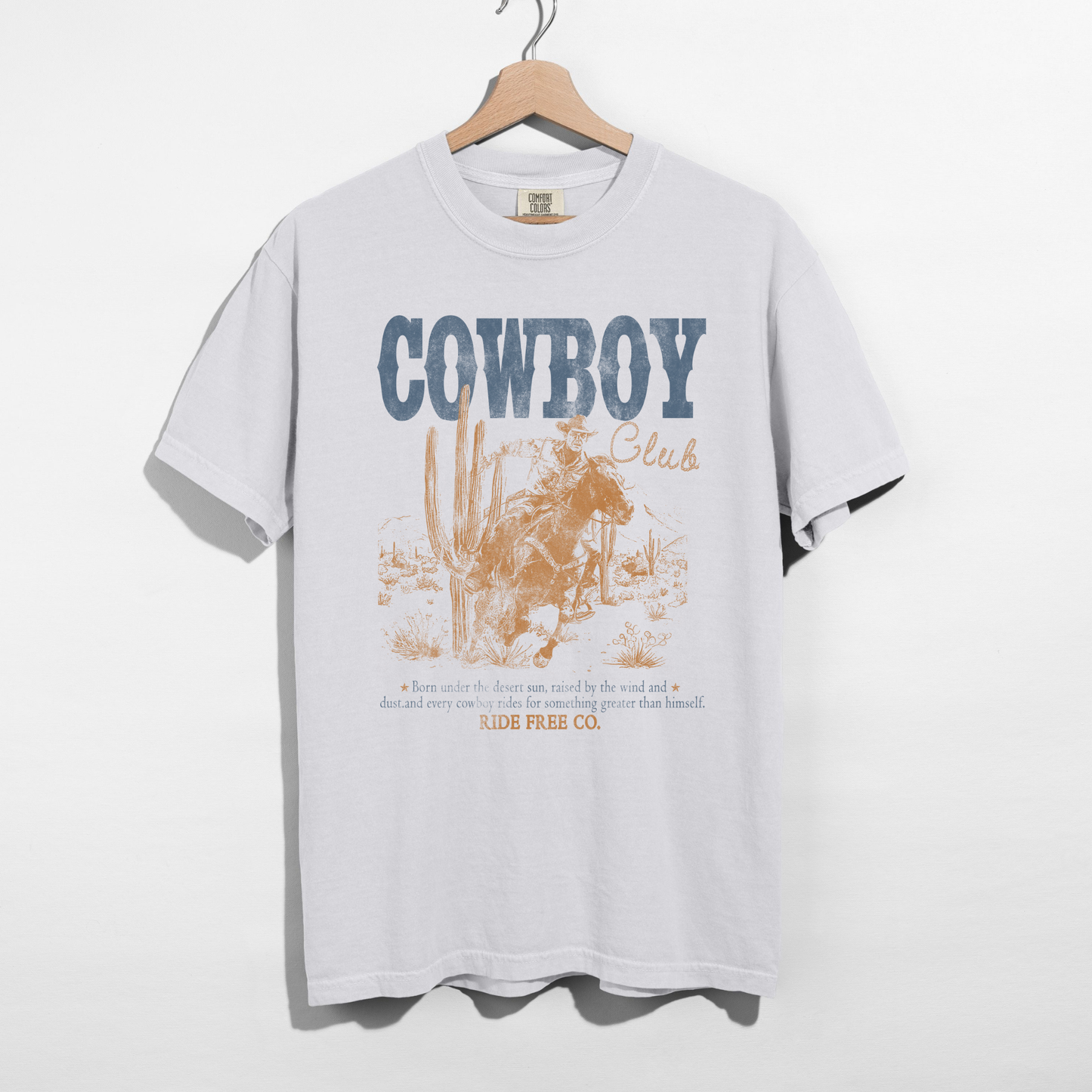 White Comfort Colors cowboy club graphic tee with vintage western cowboy illustration on hanger