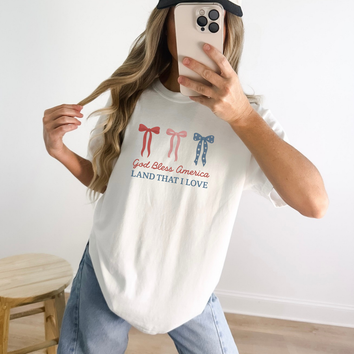 Woman wearing God Bless America bow graphic tee with red white and blue bows