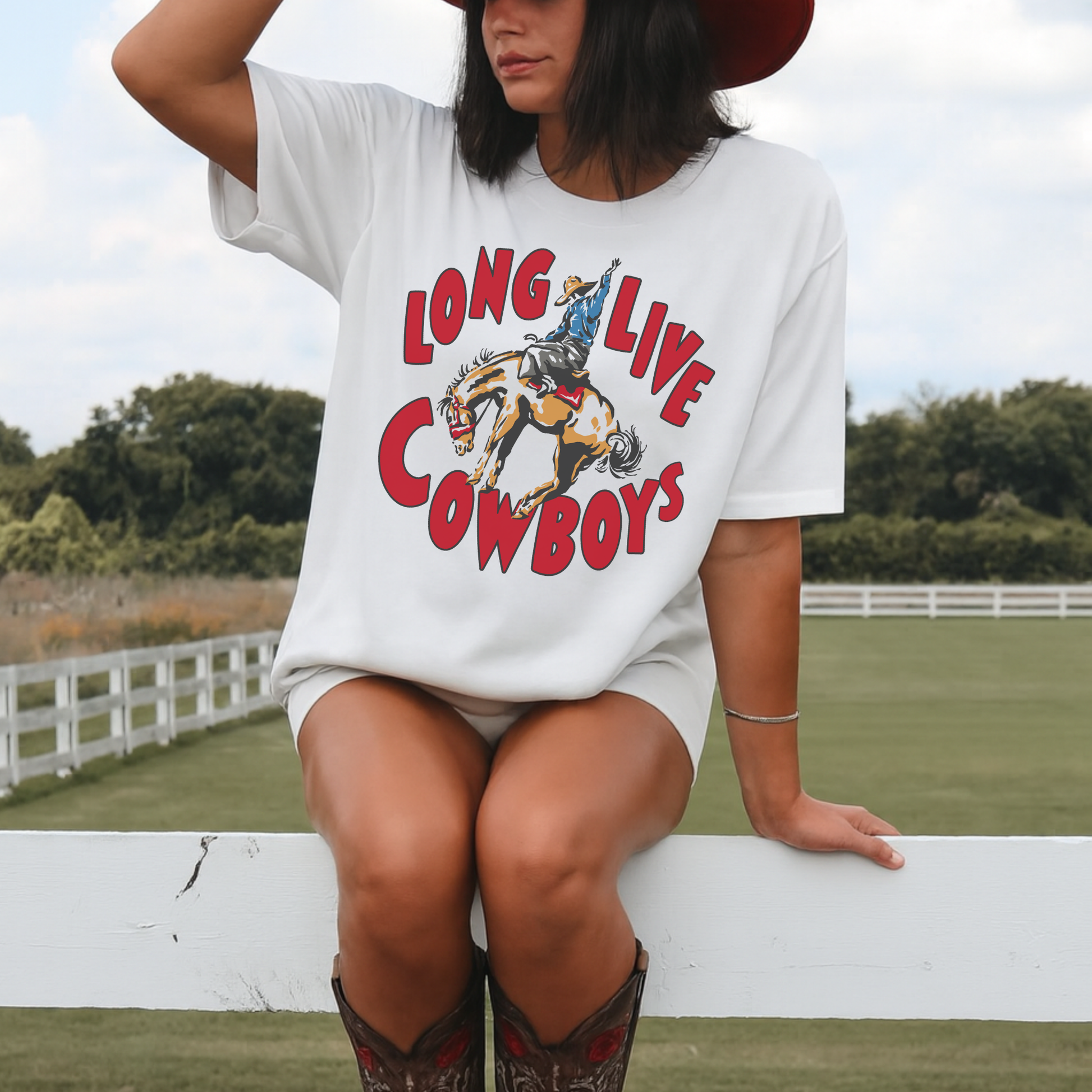 Western Long Live Cowboys graphic tee styled with cowboy boots outdoors