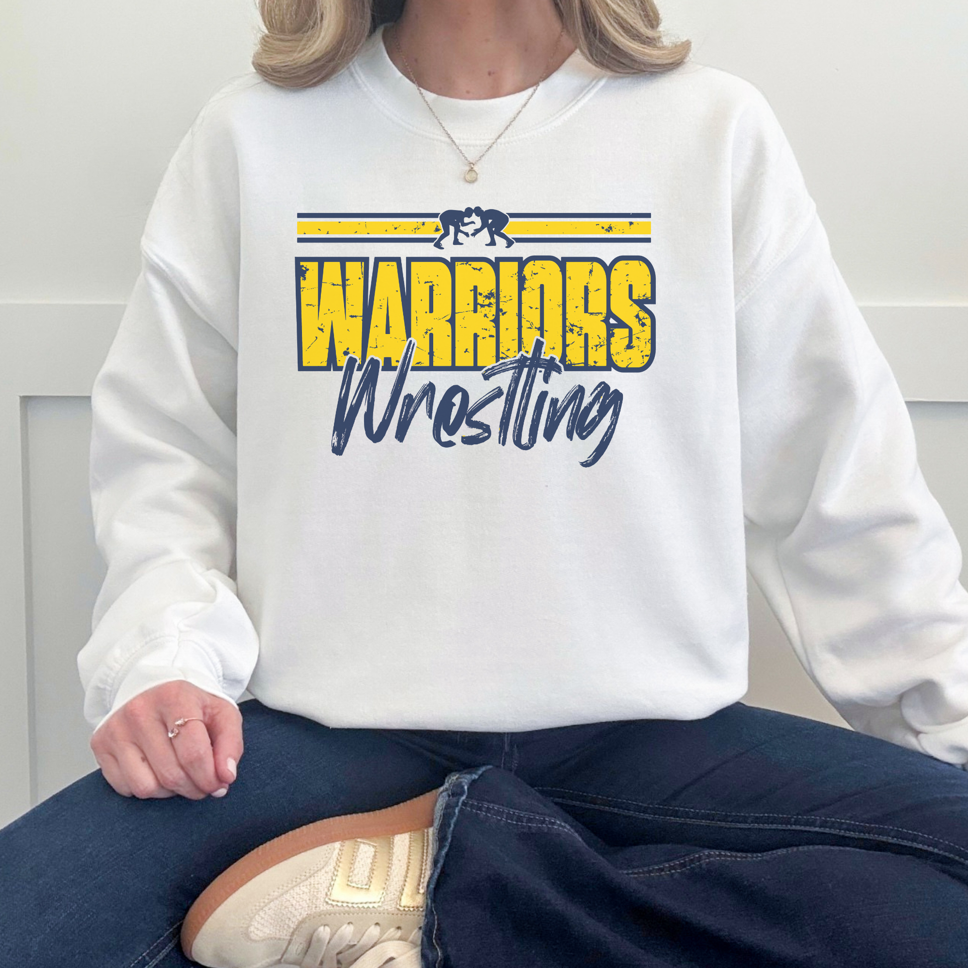 Model wearing Warriors Wrestling crewneck sweatshirt in white with vintage athletic wrestling design for Sterling High School spirit wear
