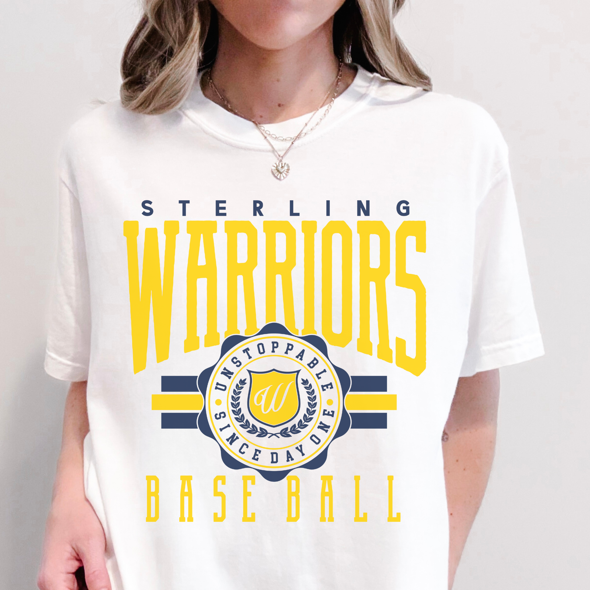 Person wearing a white t-shirt with 'Sterling Warriors' and 'Unstoppable Since Day One' text.