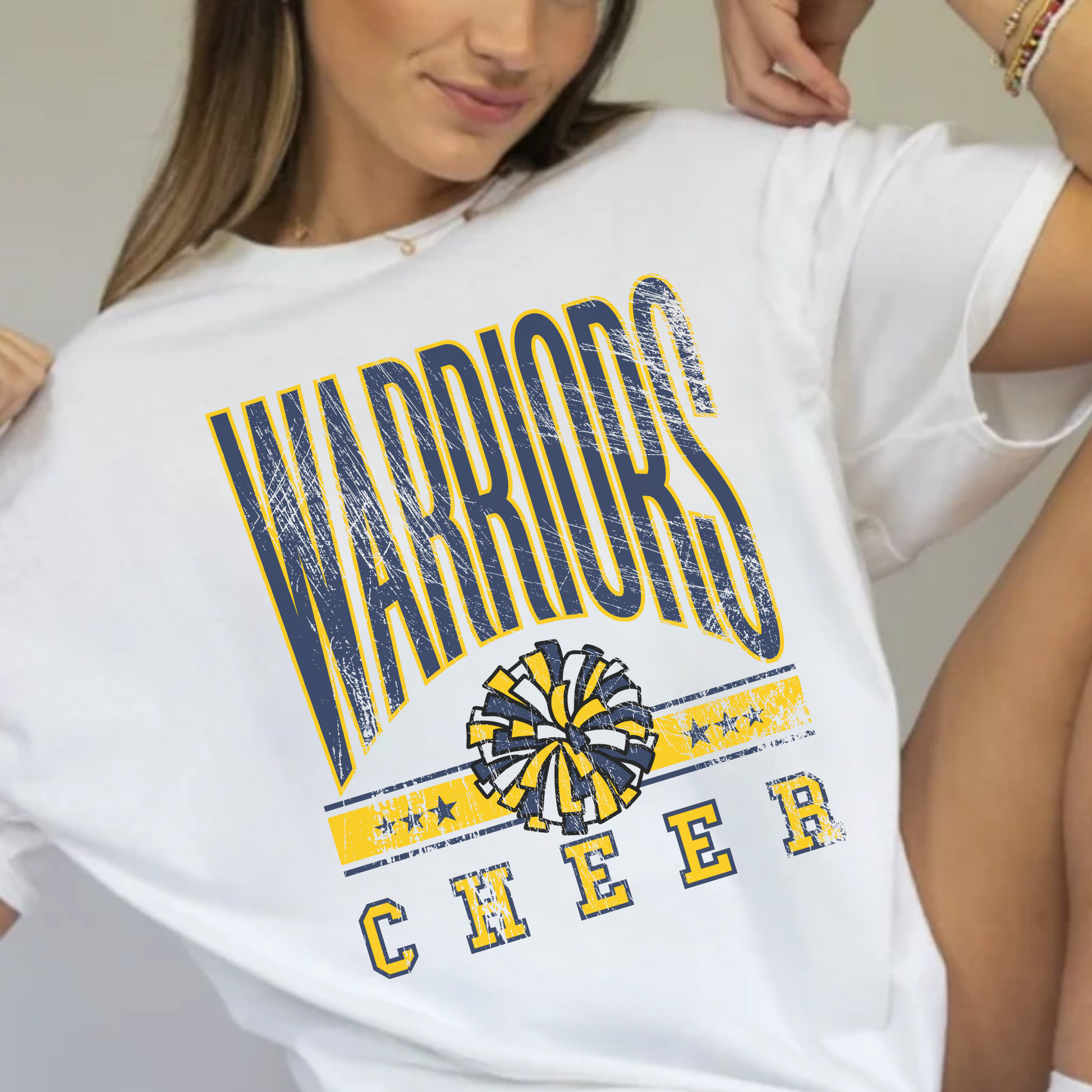 Woman wearing white Warriors Cheer vintage unisex school spirit t shirt with distressed collegiate graphic