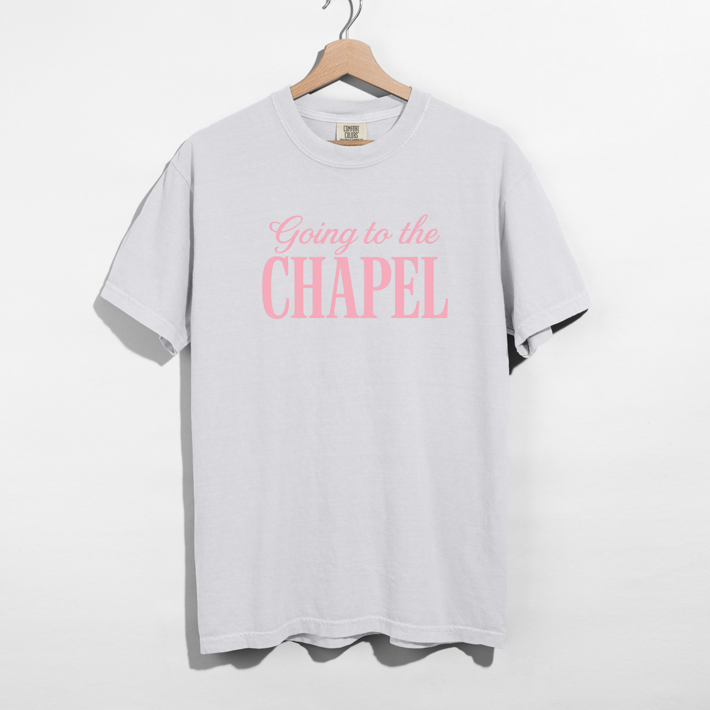 White oversized bridal graphic tee worn by model with pink “Going to the Chapel” lettering