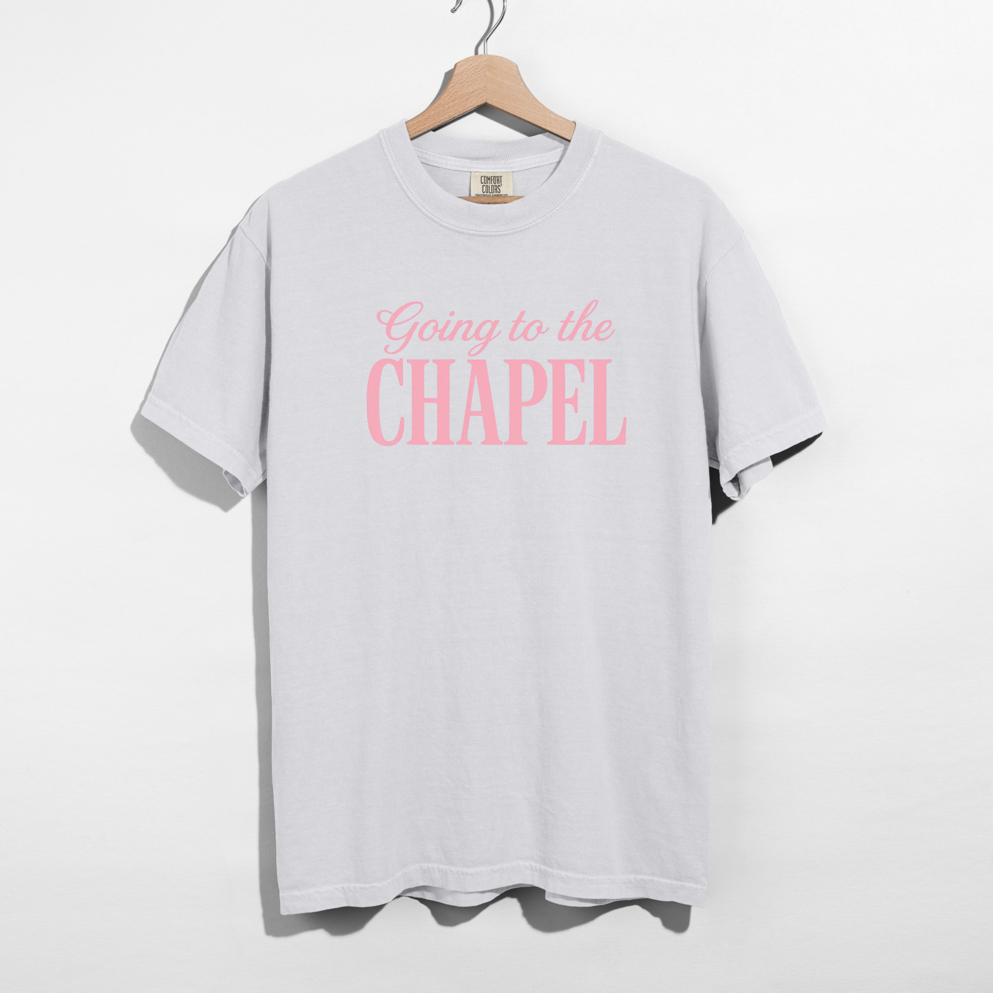 White oversized bridal graphic tee worn by model with pink “Going to the Chapel” lettering