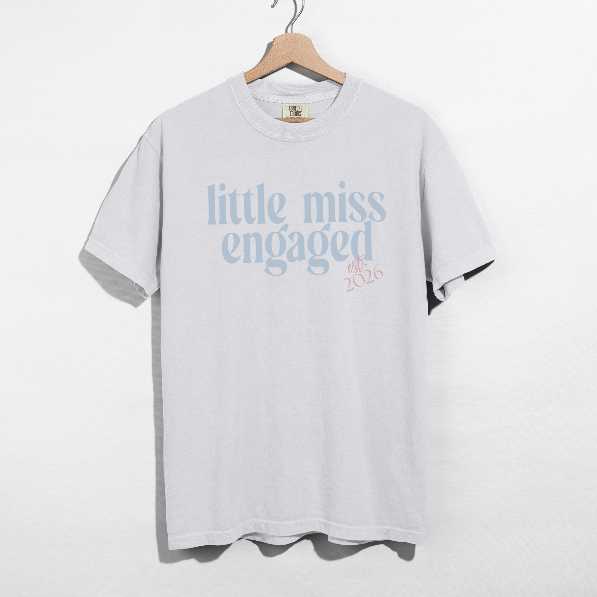 White Little Miss Engaged Est. 2026 engagement t-shirt flat lay