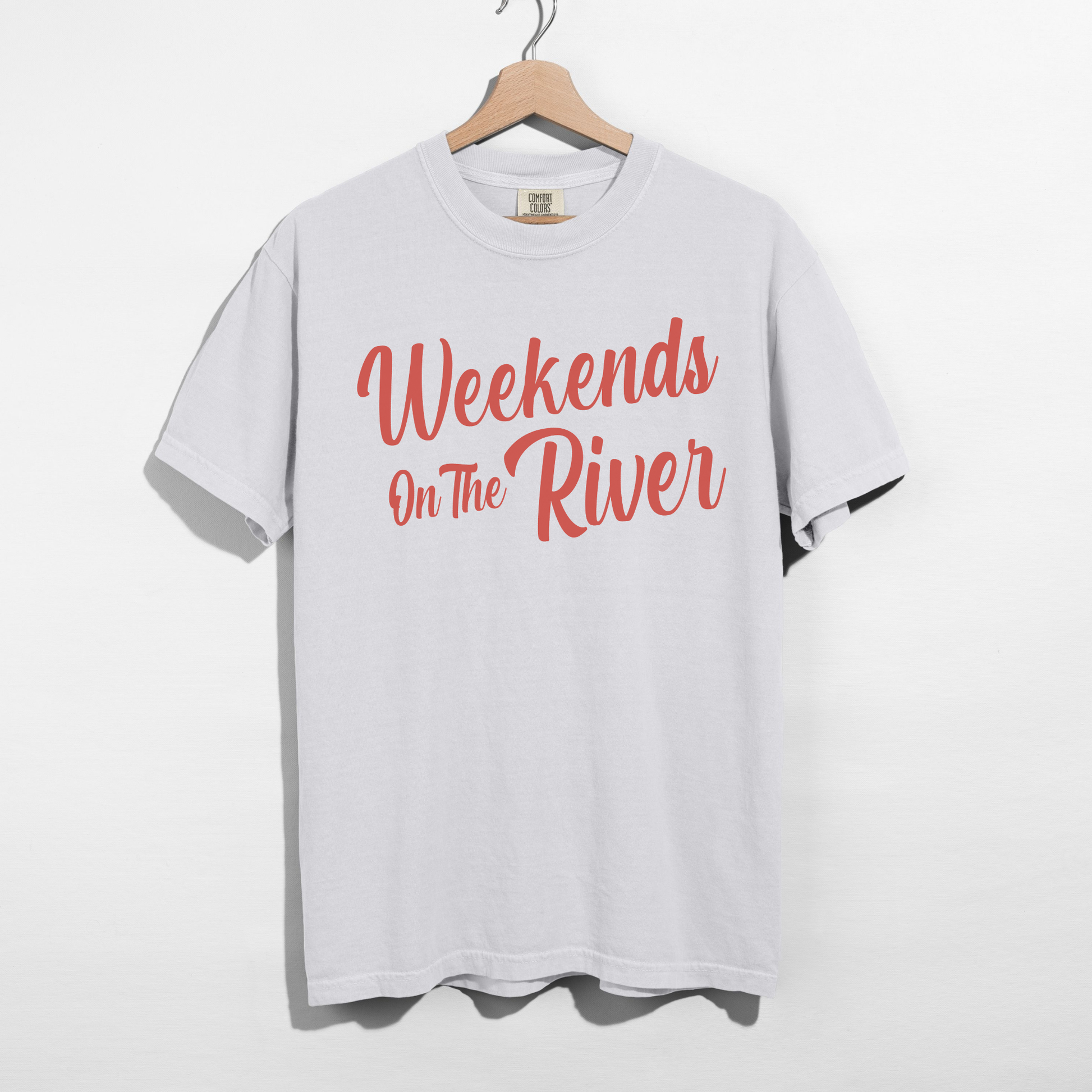 White Comfort Colors garment-dyed t-shirt with coral red “Weekends On The River” summer graphic printed on the front.