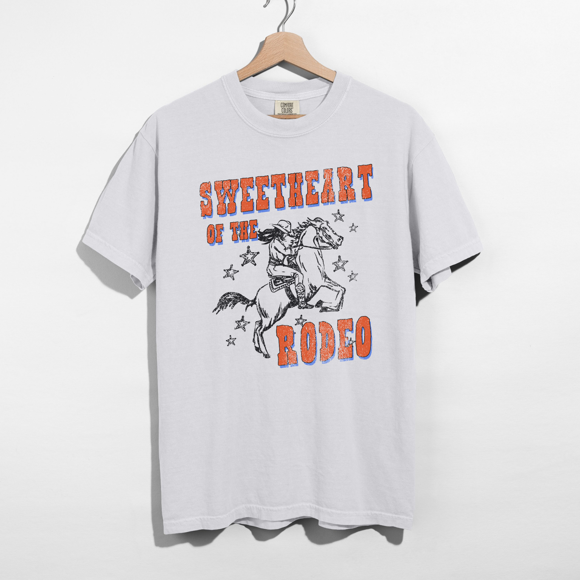 white comfort colors western graphic tee with rodeo horse design and vintage lettering
