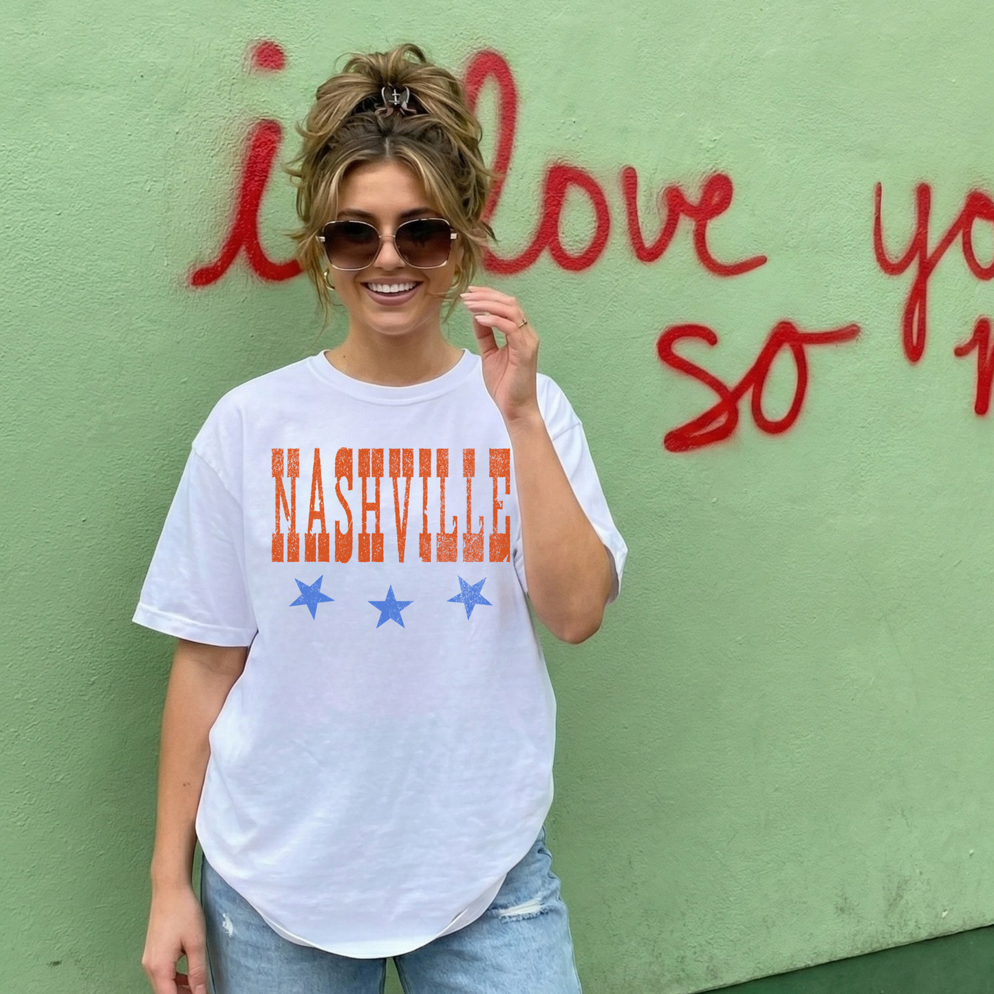 Woman wearing white Nashville graphic t-shirt with stars and distressed lettering casual everyday outfit
