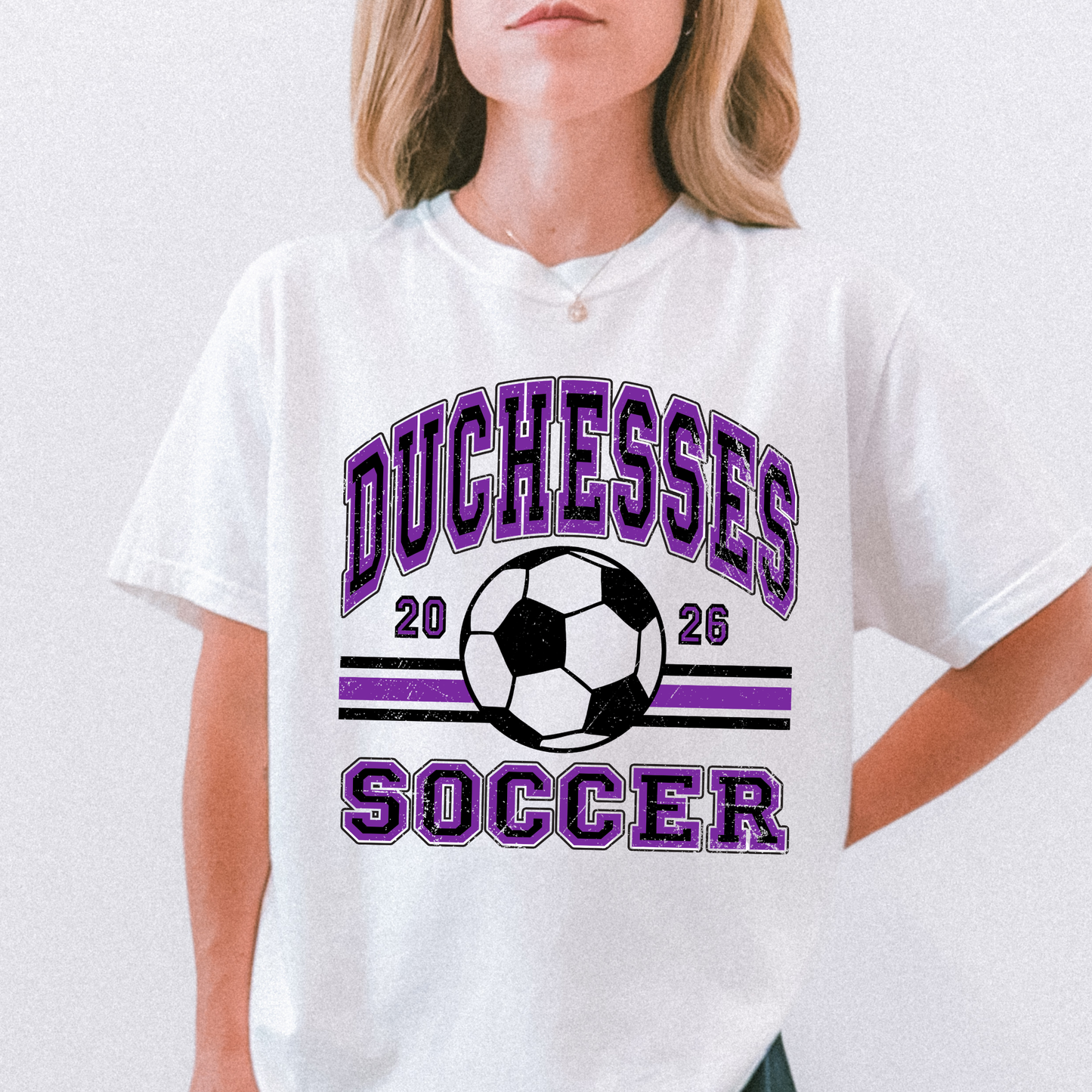 Close up of Duchesses Soccer 2026 shirt on model wearing white tee