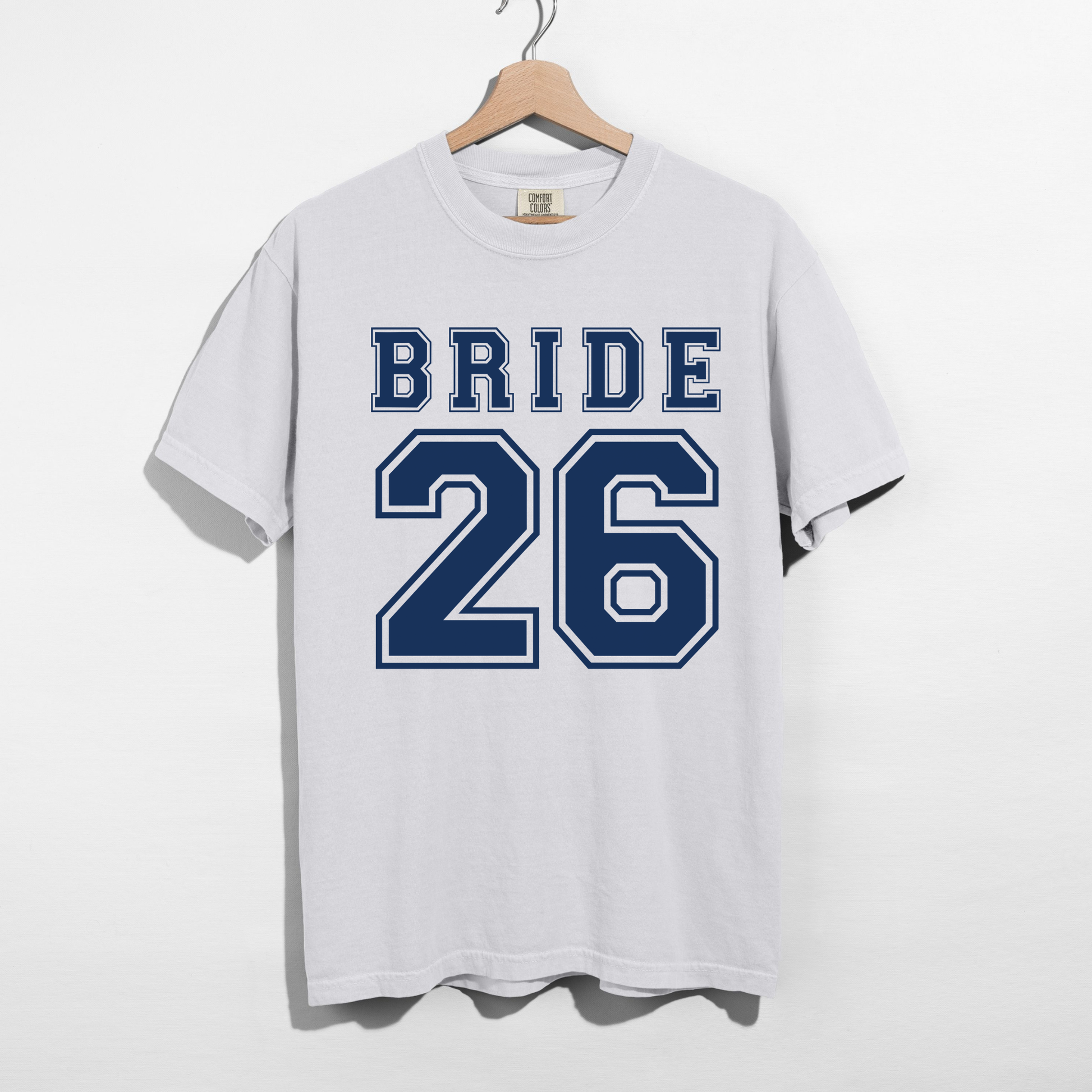 White Comfort Colors Bride 26 varsity bridal t-shirt mockup with oversized collegiate numbers