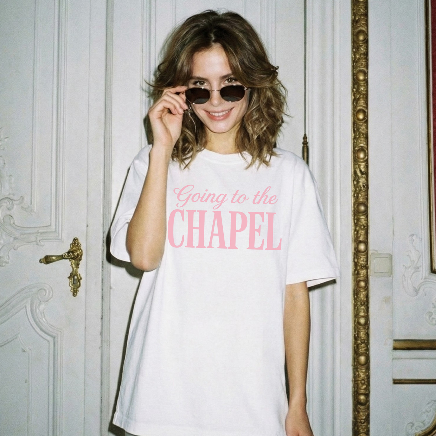 White oversized bridal graphic tee worn by model with pink “Going to the Chapel” lettering
