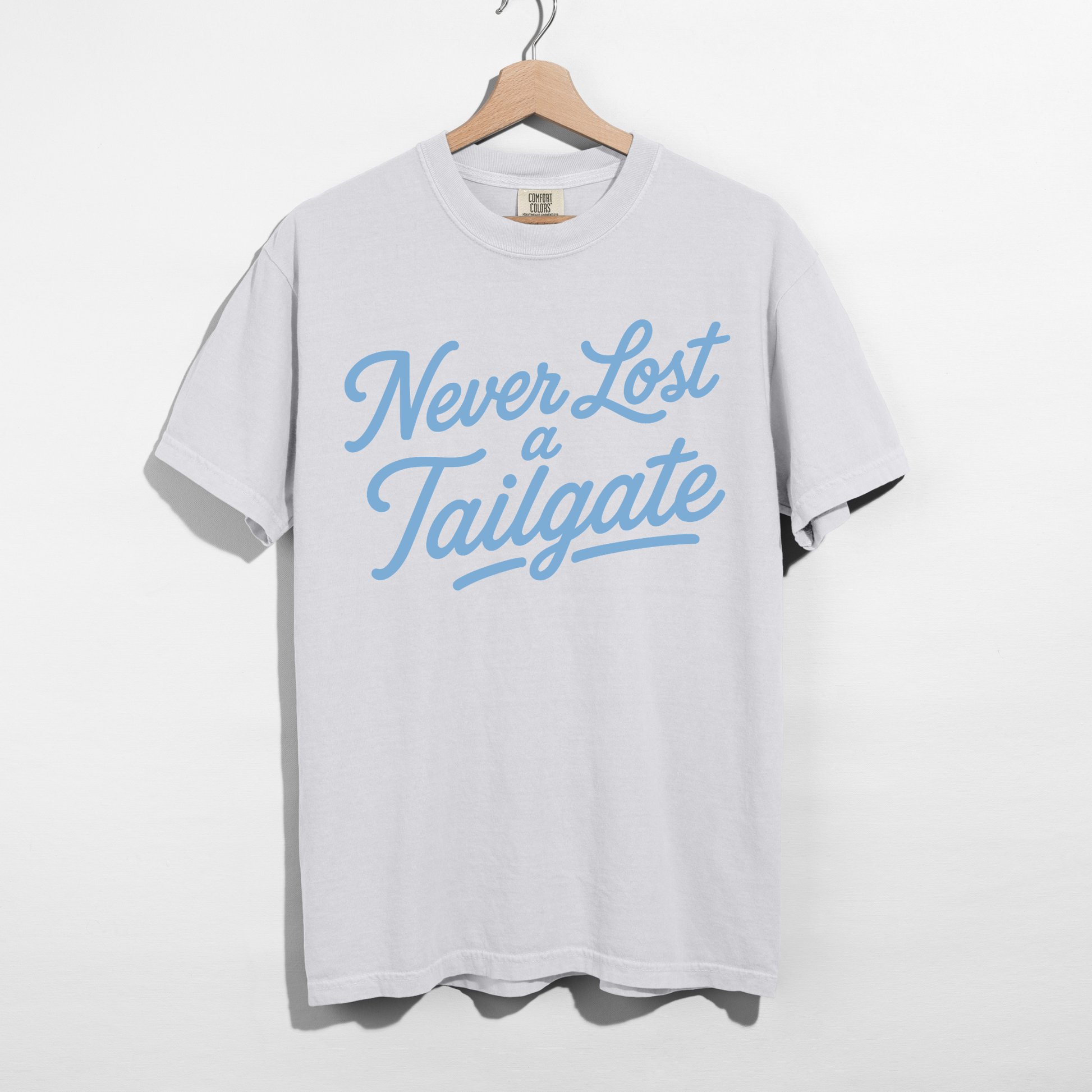 Never Lost a Tailgate white graphic tee with Carolina blue retro lettering for football game day