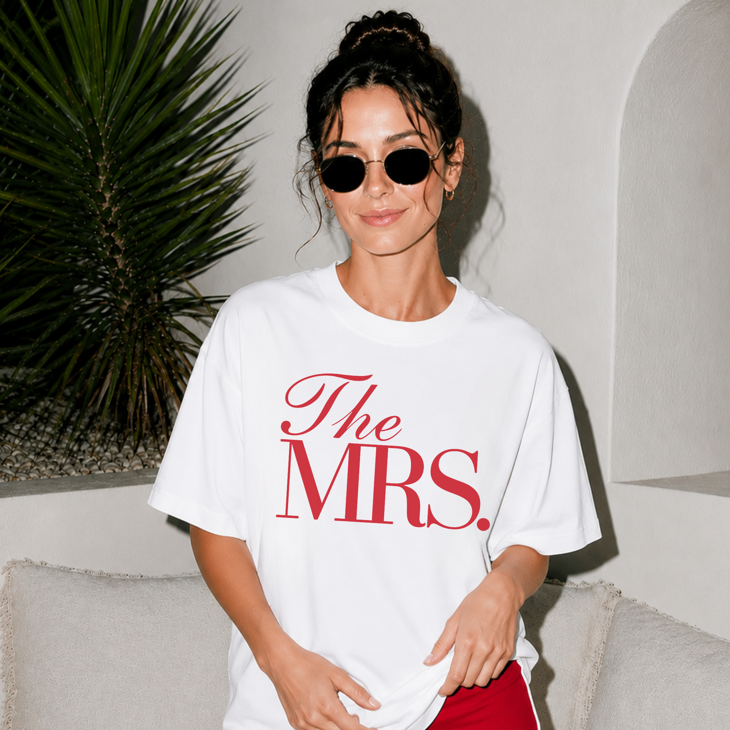 Front-facing model wearing a white oversized The Mrs. bridal graphic t-shirt featuring classic red typography, perfect for newlyweds, engagement celebrations, and bachelorette weekends.