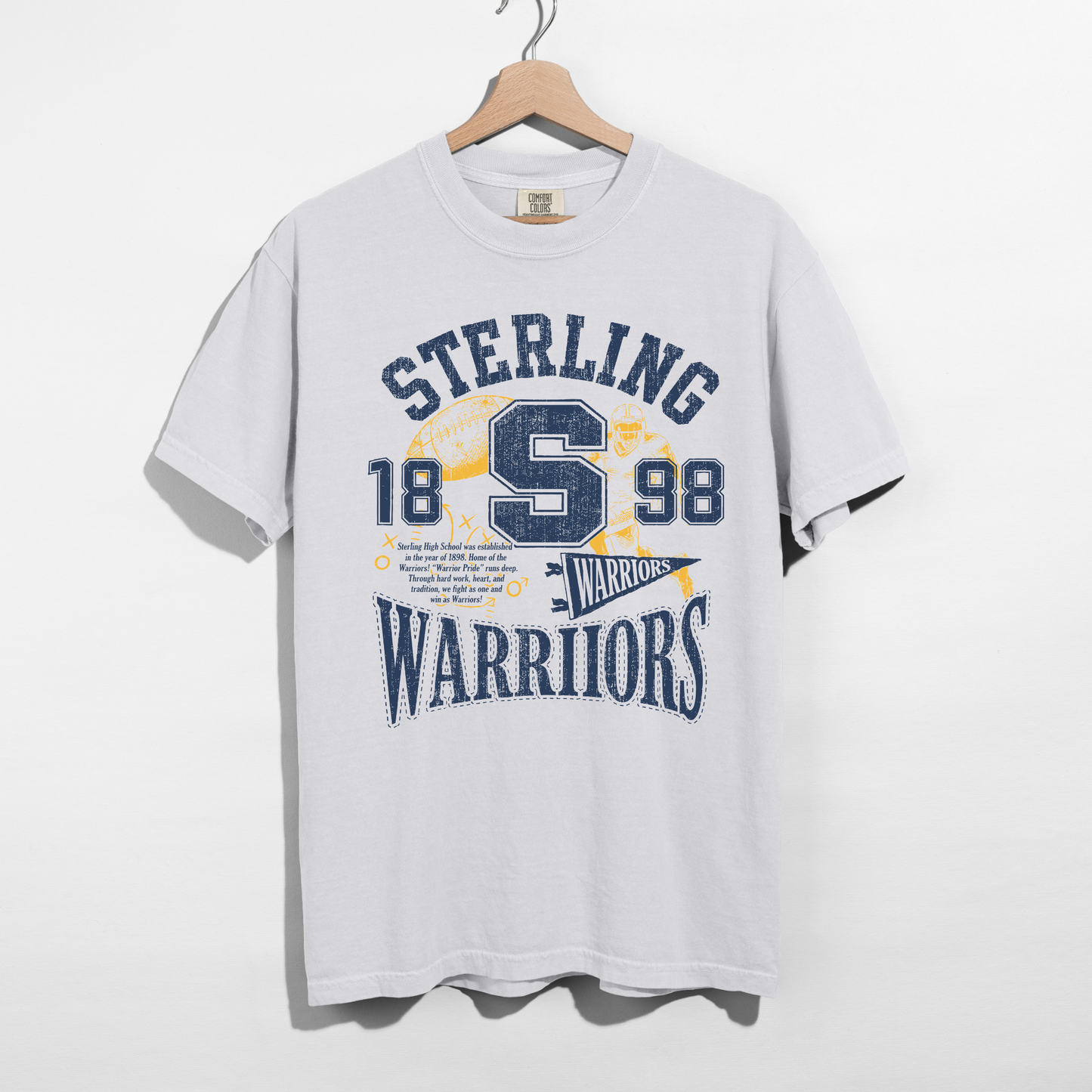 White Sterling Warriors Football graphic t-shirt featuring distressed varsity lettering, collegiate "S," football graphics, and vintage navy and gold design.