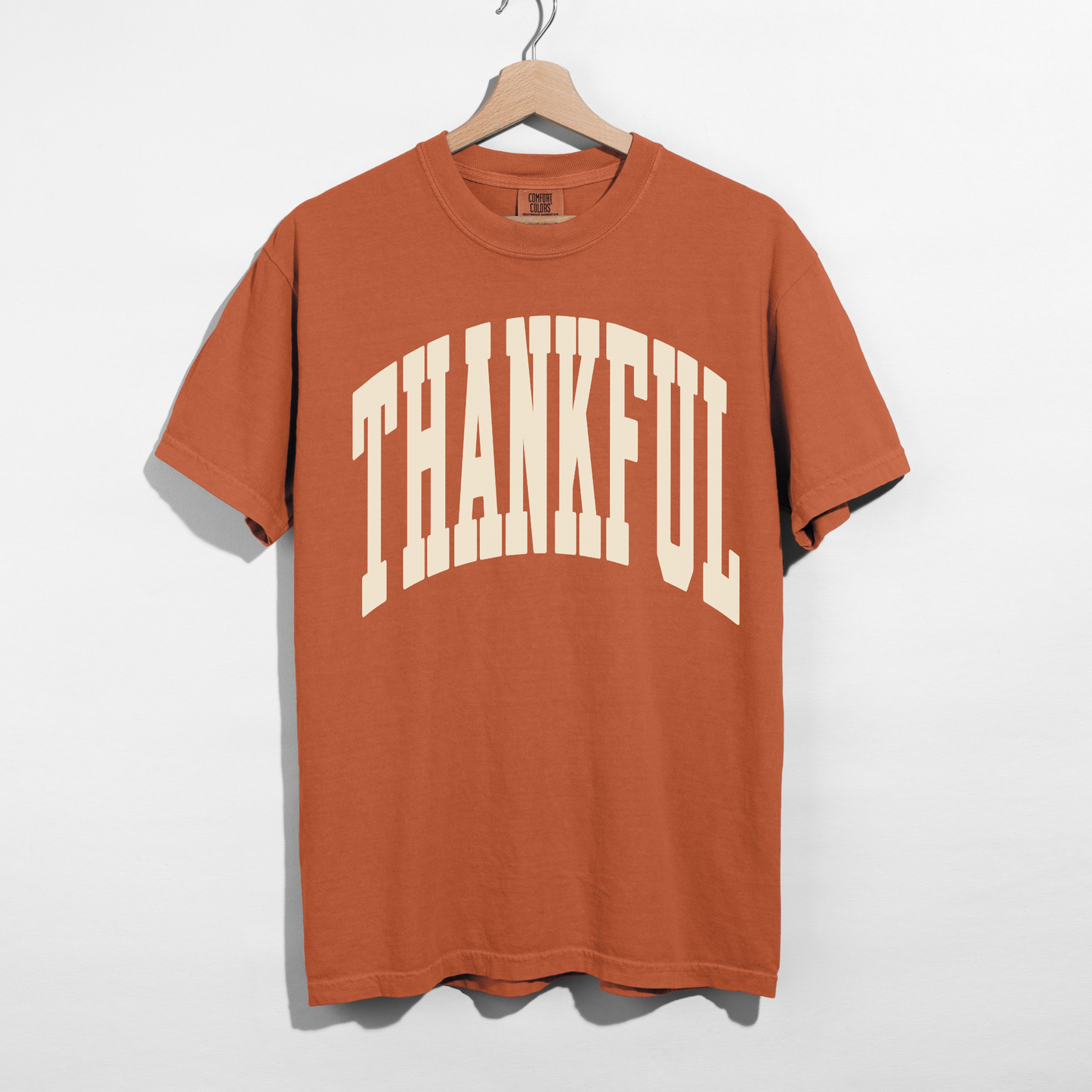 Yam orange Thankful graphic tee with oversized cream collegiate lettering for a fall Thanksgiving outfit