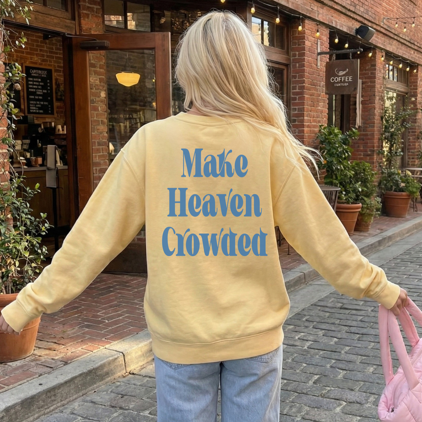 Back view yellow Make Heaven Crowded sweatshirt with large blue faith graphic